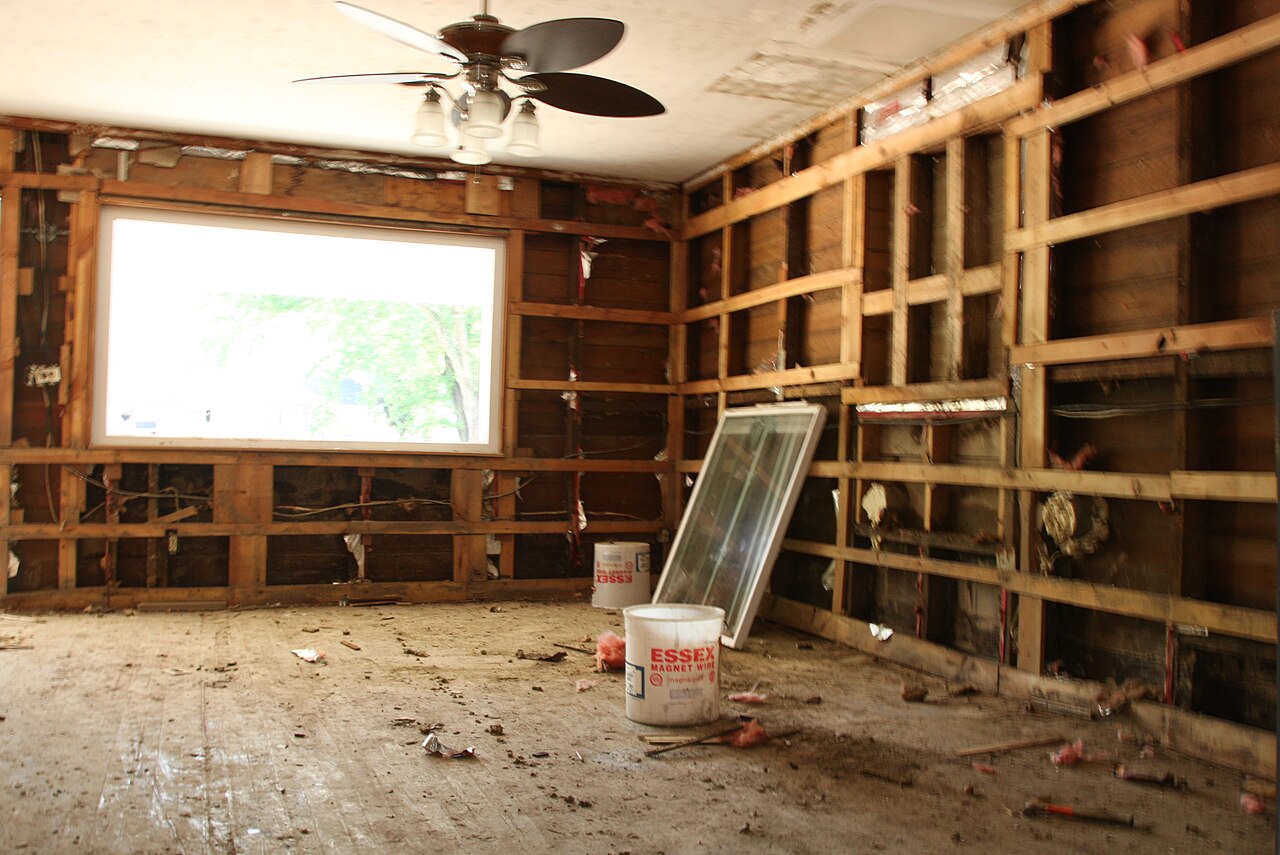 Flood-damaged home interior stripped to the wall studs for restoration